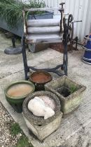A washing mangle and four concrete planters