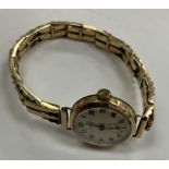 A 9 carat gold cased ladies Evoy wristwatch, the circular silvered dial with Arabic numerals,