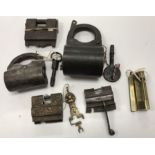 A collection of 6 various Eastern iron / brass padlocks including a large barrel form example with