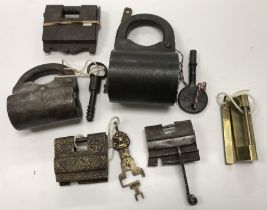 A collection of 6 various Eastern iron / brass padlocks including a large barrel form example with