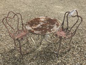 A French style painted wrought iron circular cafe table and two matching chairs