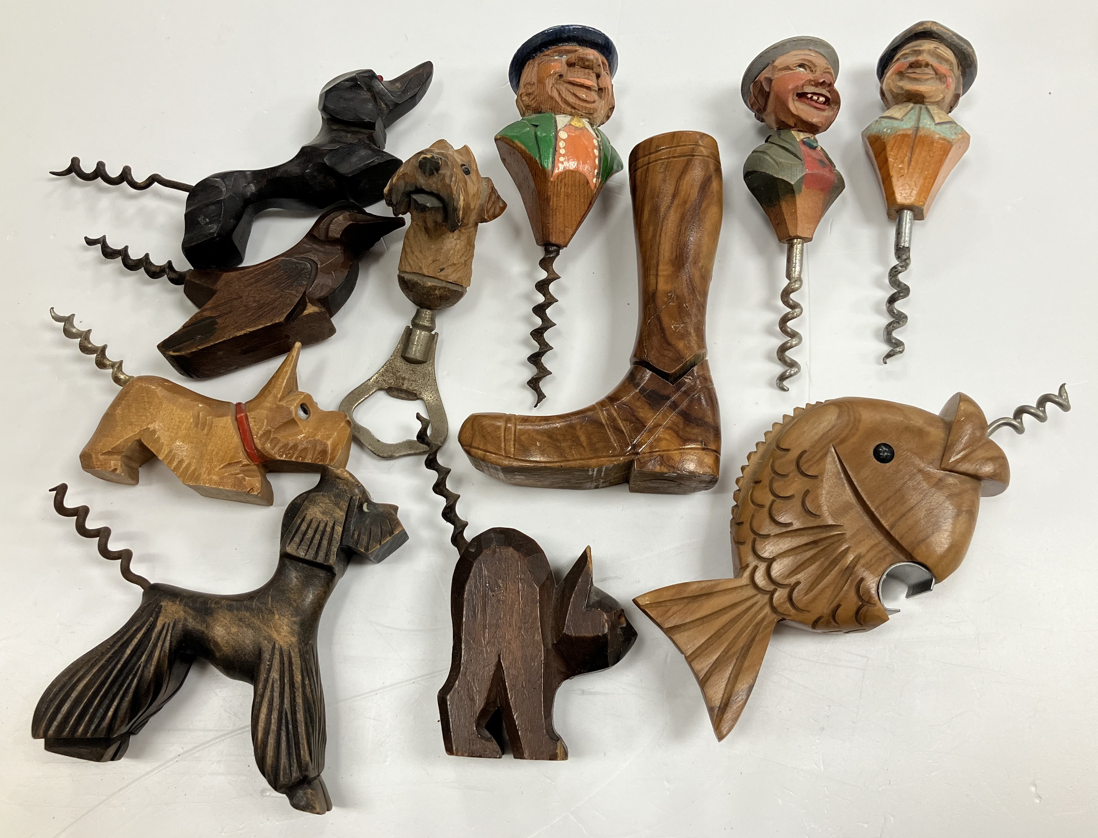 A collection of carved wooden handled corkscrews with figural / animal, etc.