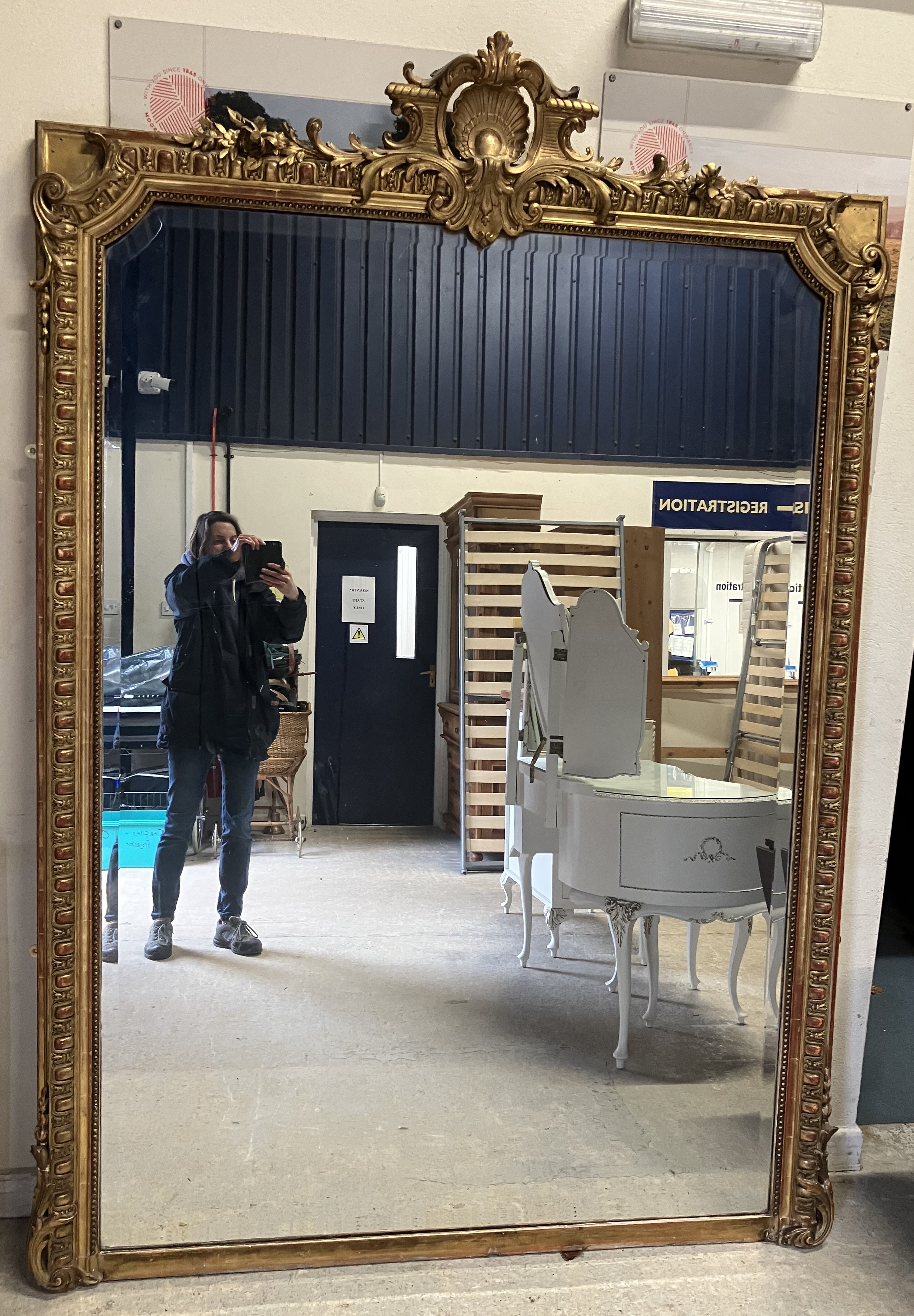 A Victorian carved giltwood and gesso framed over mantel mirror with shell and foliate carved