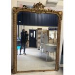 A Victorian carved giltwood and gesso framed over mantel mirror with shell and foliate carved