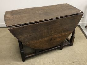An oak oval gate-leg drop-leaf dining table in the 17th Century manner,