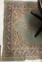 A Caucasian rug, the central panel set with a diamond medallion with floral decorated ground,
