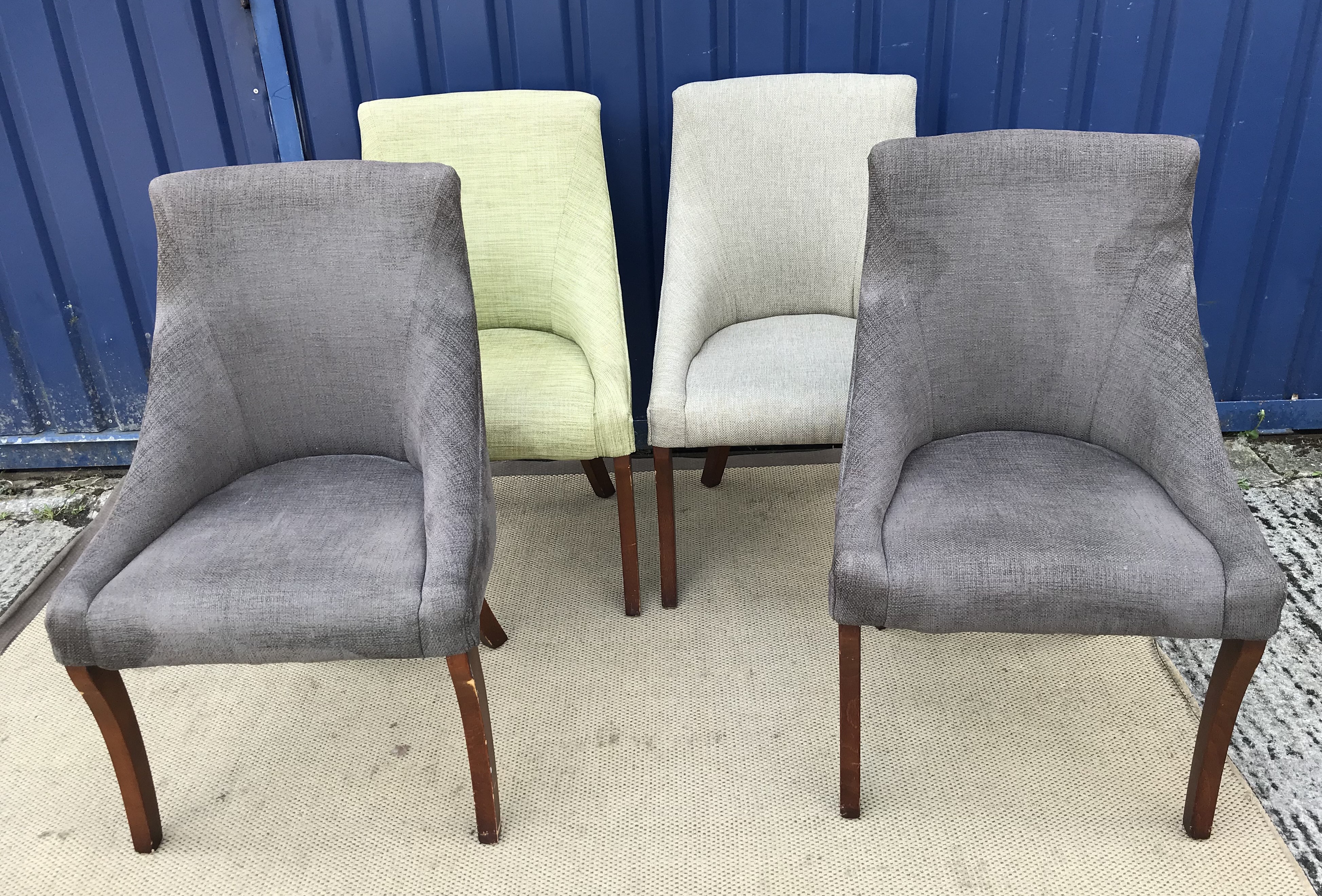 A collection of four similar upholstered reception chairs on sabre legs