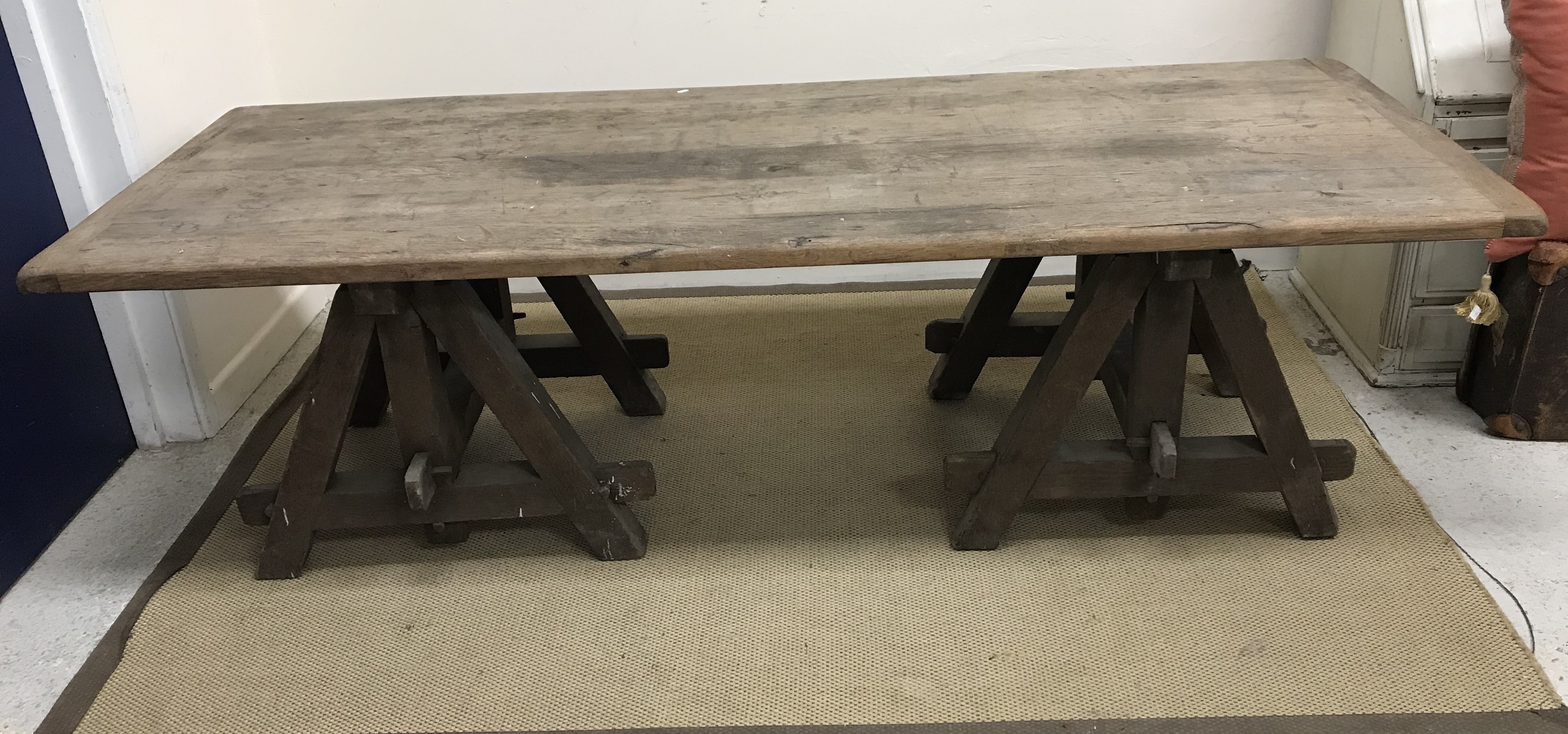 A late 19th/early 20th Century French oak low trestle table, 126 cm long x 86 cm wide x 65.