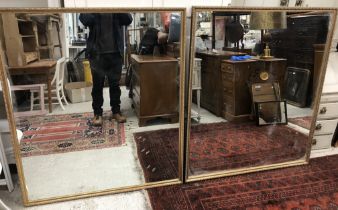 A large pair of modern gilt framed rectangular wall mirrors,