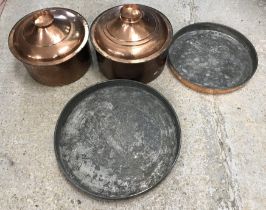 Two traditional Cypriot copper cooking vessels and covers, one 40 cm diameter x 20 cm high,