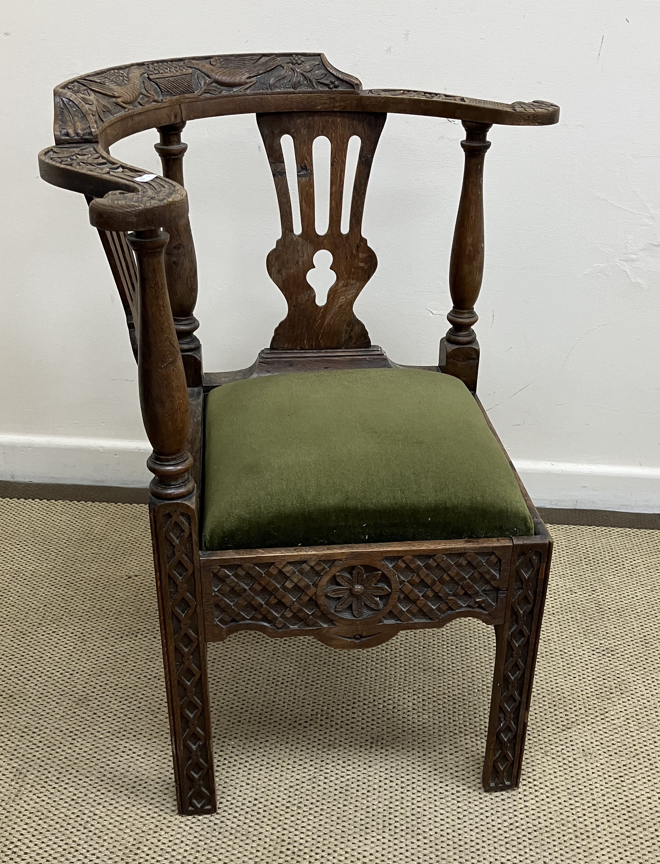 A 19th Century oak corner chair in the 18th Century style,