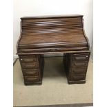 An early 20th Century oak roll top desk,