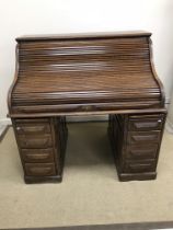 An early 20th Century oak roll top desk,