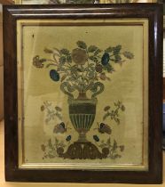 A 19th Century felted picture depicting Classical twin handled urn with floral sprays and