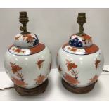 A pair of Japanese porcelain butterfly and flower decorated table lamps of ginger jar form in the
