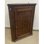 A circa 1800 North Country oak and cross-banded hanging corner cupboard,