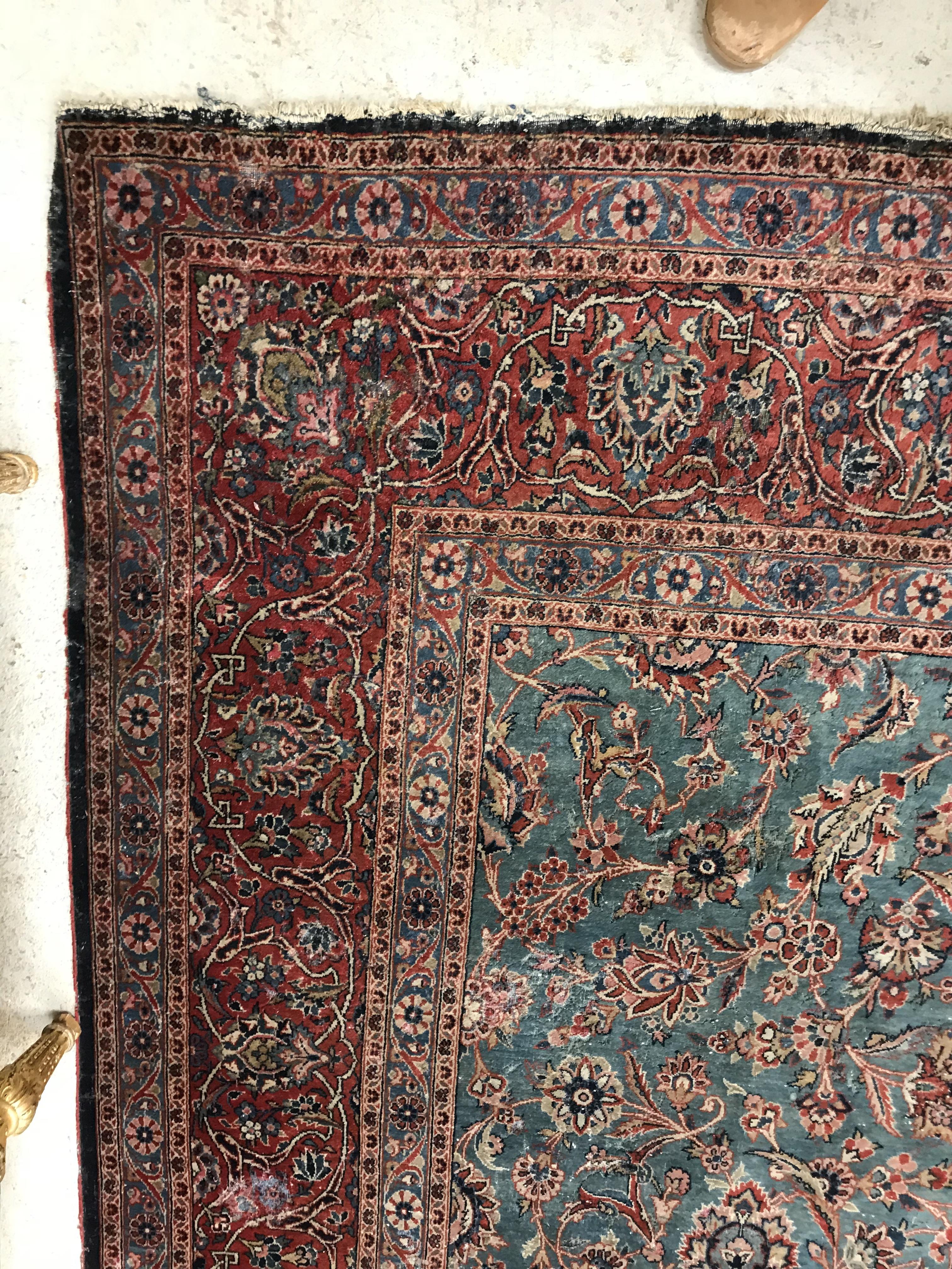 A Persian carpet, the central panel set with all-over scrolling foliate design on a teal ground, - Image 5 of 41