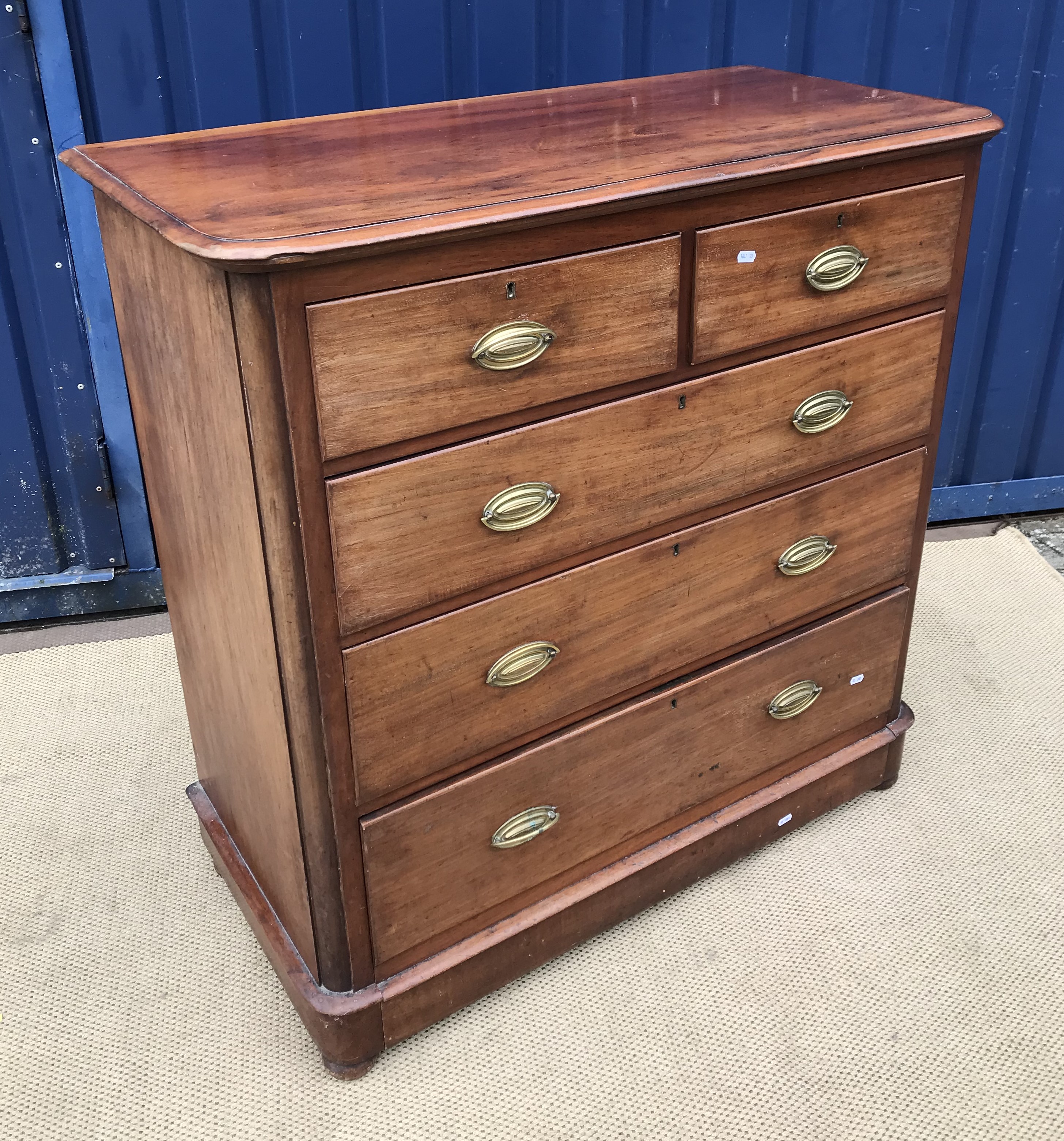 A late Victorian mahogany chest of two short over three long graduated drawers on turned feet,