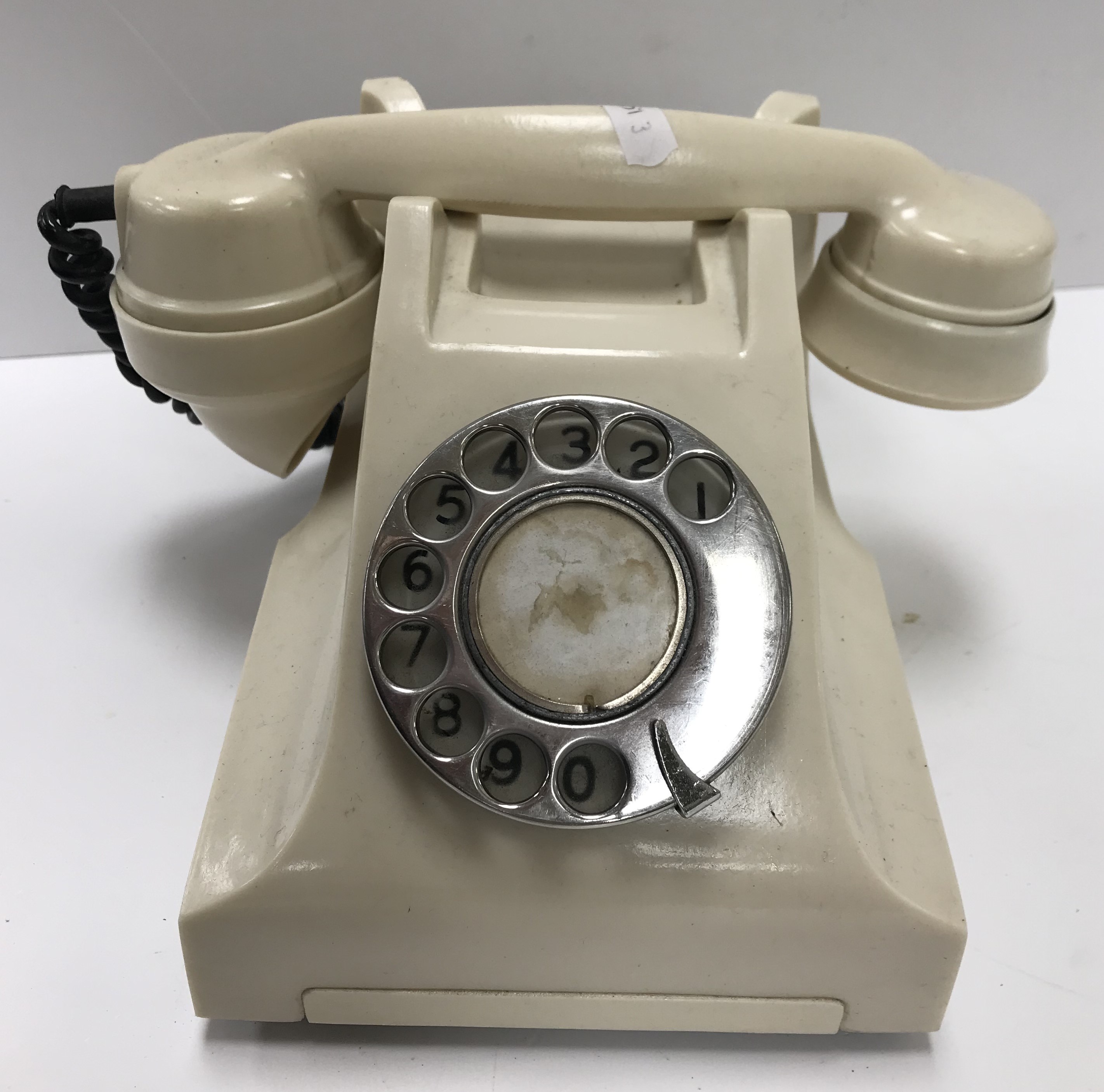 An ivory bakelite/plastic type cased telephone bearing label to base "Teknika Electronics OK