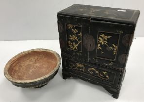 A 19th Century Japanese black lacquered and gilt decorated table top cabinet with two doors