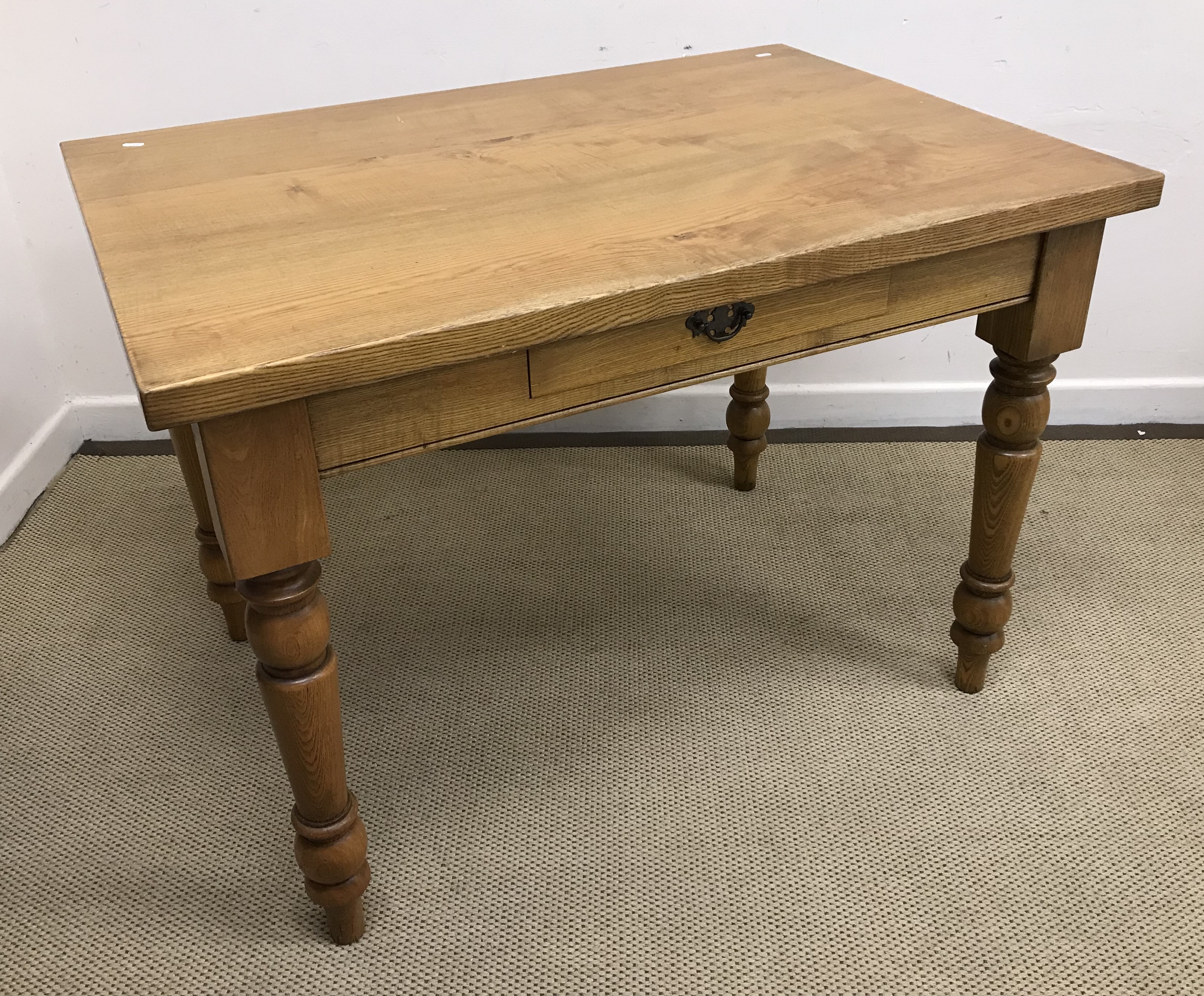 A Stuart Linford oak dining table,