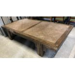 A 20th Century Indonesian teak and rattan low table / day bed, on square supports,