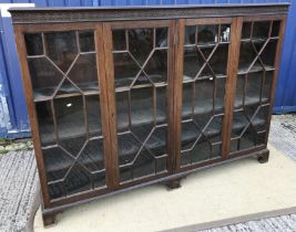 An early 20th Century oak bookcase cabinet in the Georgian taste,