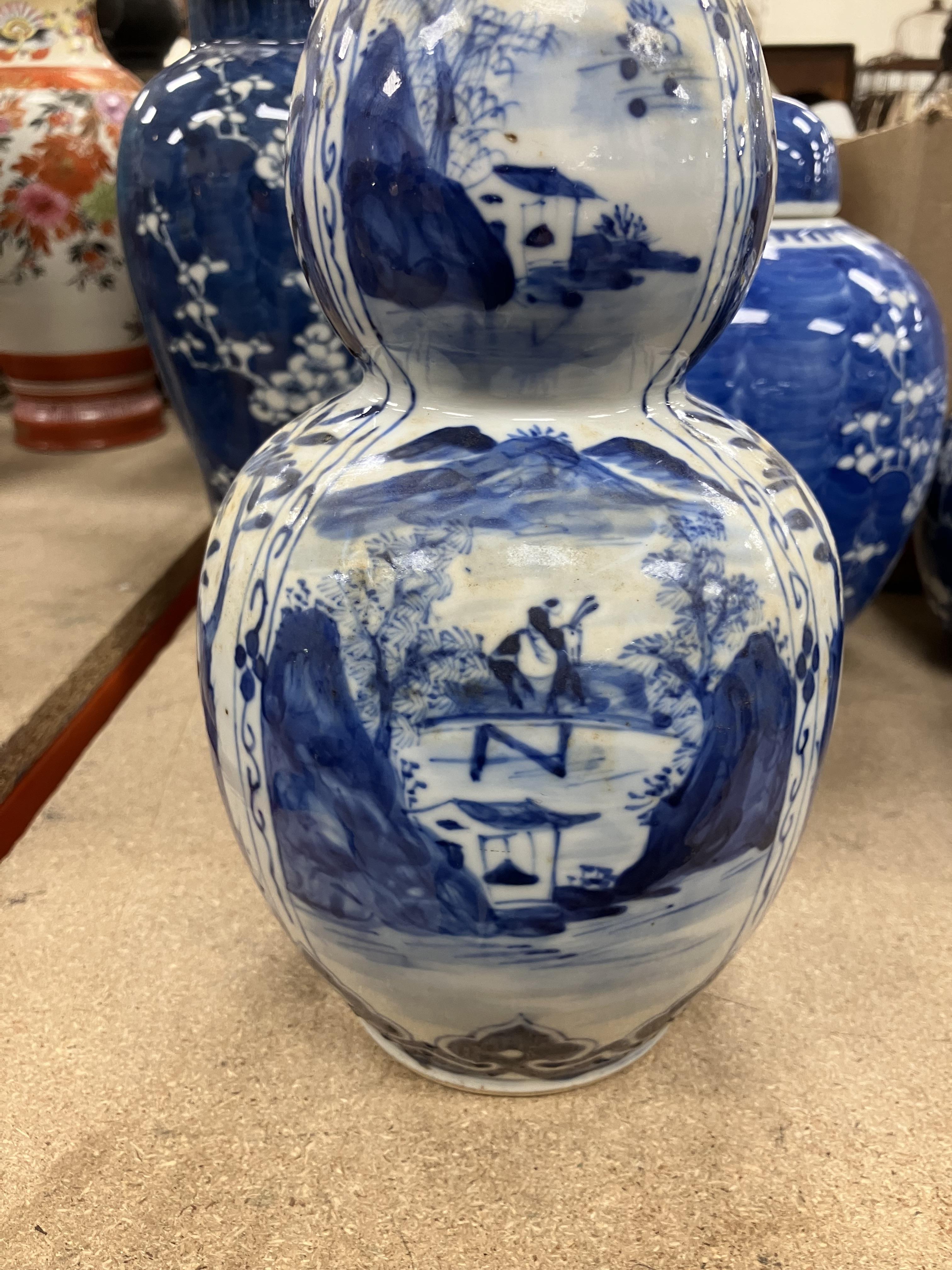 A Chinese blue and white double gourd shaped vase decorated with panels of figures in watery - Image 17 of 26