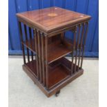An Edwardian mahogany and inlaid revolving bookcase,