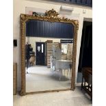 A Victorian carved giltwood and gesso framed over mantel mirror with shell and foliate carved