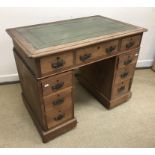 A late Victorian walnut kneehole desk of small proportions,