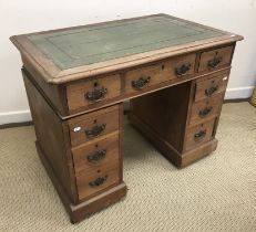 A late Victorian walnut kneehole desk of small proportions,