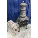 A small cast iron chiminea 95 cm high with two packets of briquettes