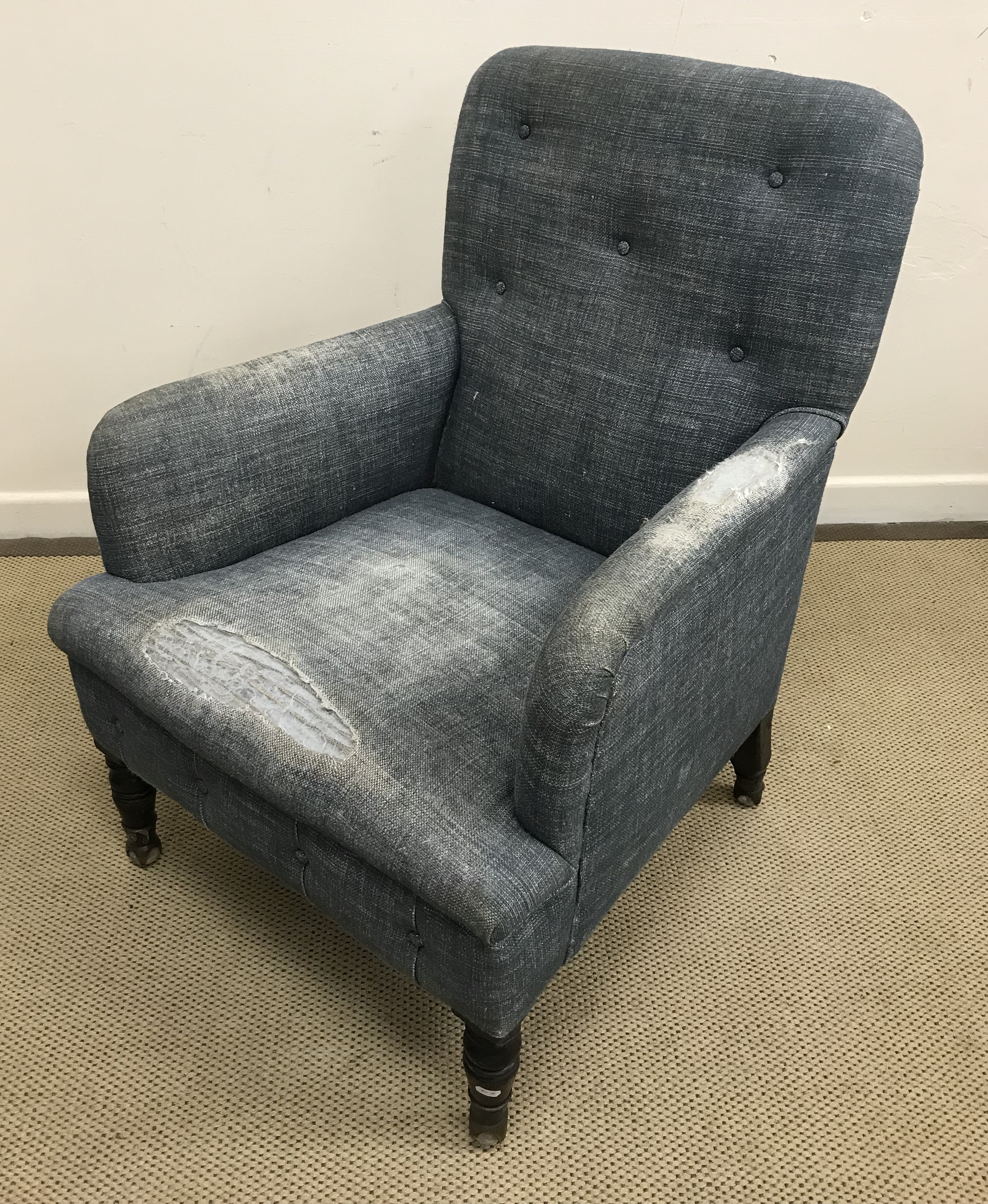 A late 19th/early 20th Century upholstered button back arm chair,