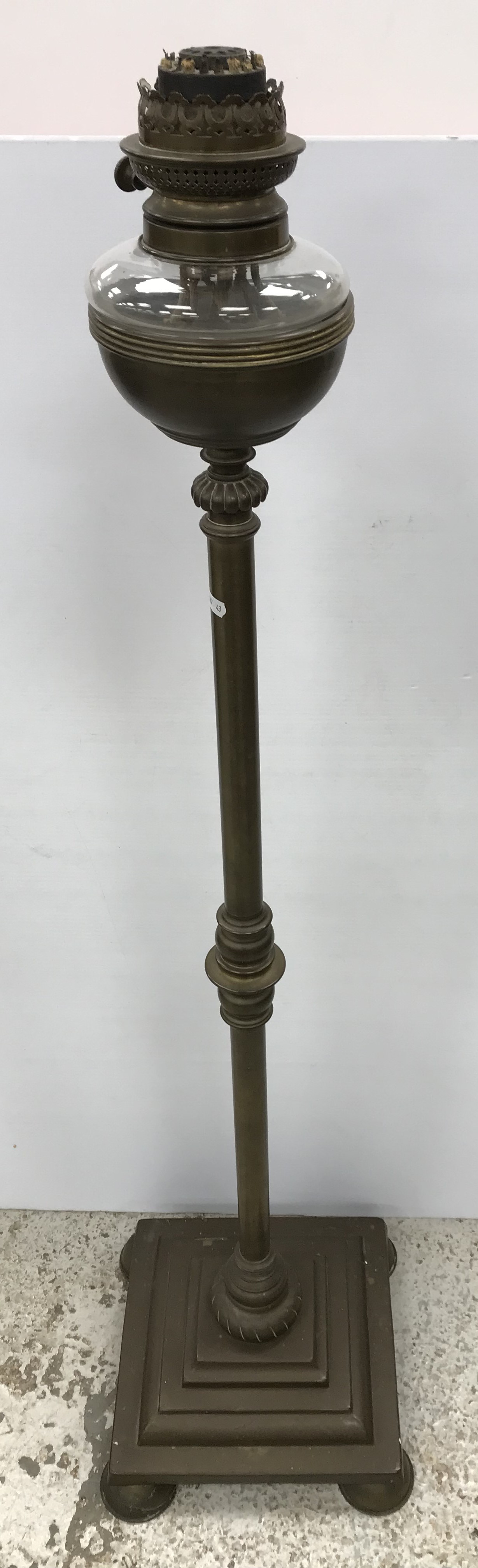 A late Victorian brass column oil standard lamp with clear glass reservoir and diamant burner 131