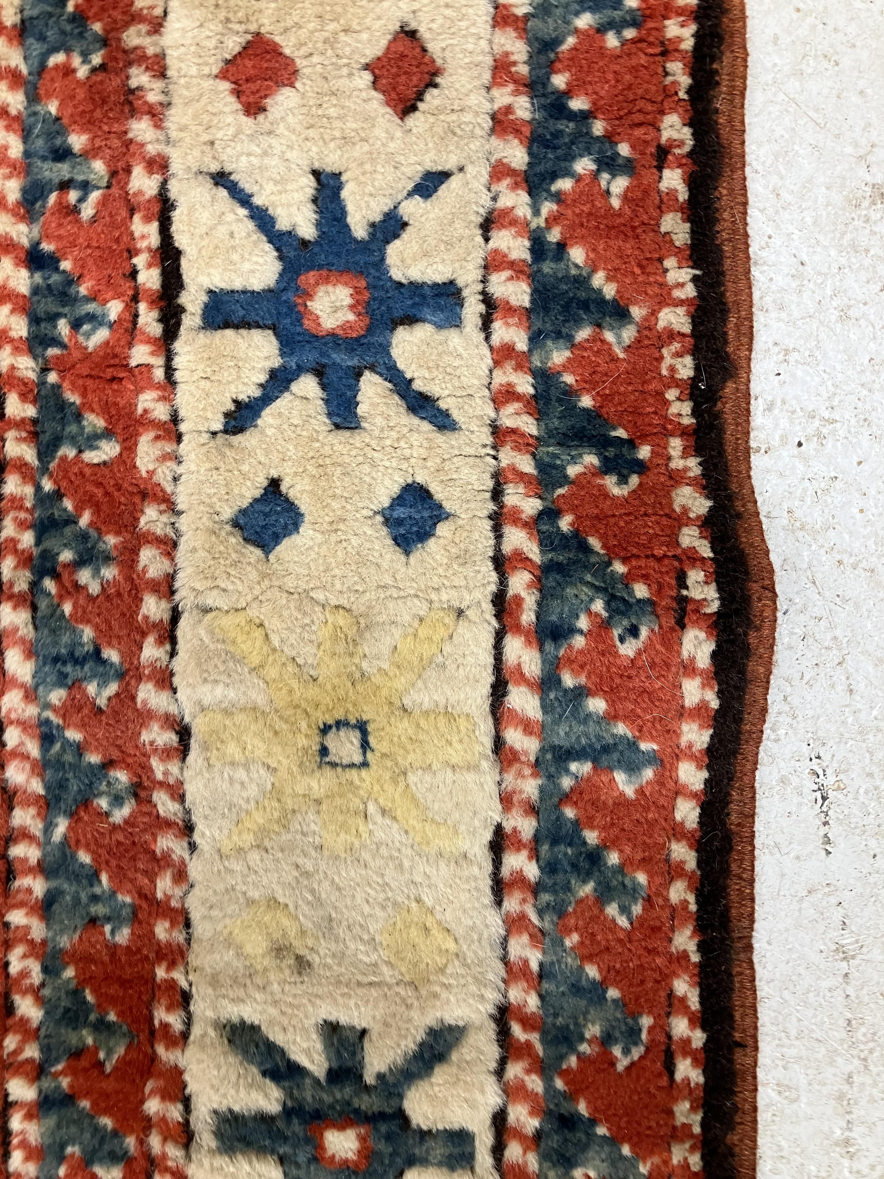A fine Turkish carpet, - Image 15 of 16