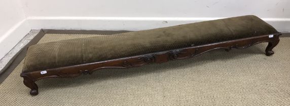 A Victorian mahogany kneeler stool with drop-in upholstered seat within a scrolling foliate