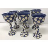 A set of six Genevieve Nielson pottery goblets with white flash on blue ground,