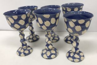 A set of six Genevieve Nielson pottery goblets with white flash on blue ground,