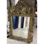 A 19th Century carved giltwood and gesso framed wall mirror in the Rococo taste with ribbon,