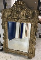 A 19th Century carved giltwood and gesso framed wall mirror in the Rococo taste with ribbon,