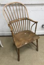 An early 19th Century West Country ash and elm stick back elbow chair,