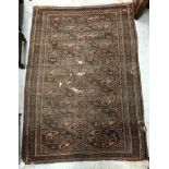 A Caucasian rug, the central panel set with stylised foliate design on a dark blue ground,