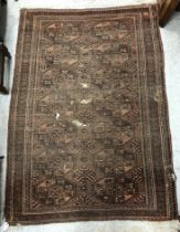 A Caucasian rug, the central panel set with stylised foliate design on a dark blue ground,