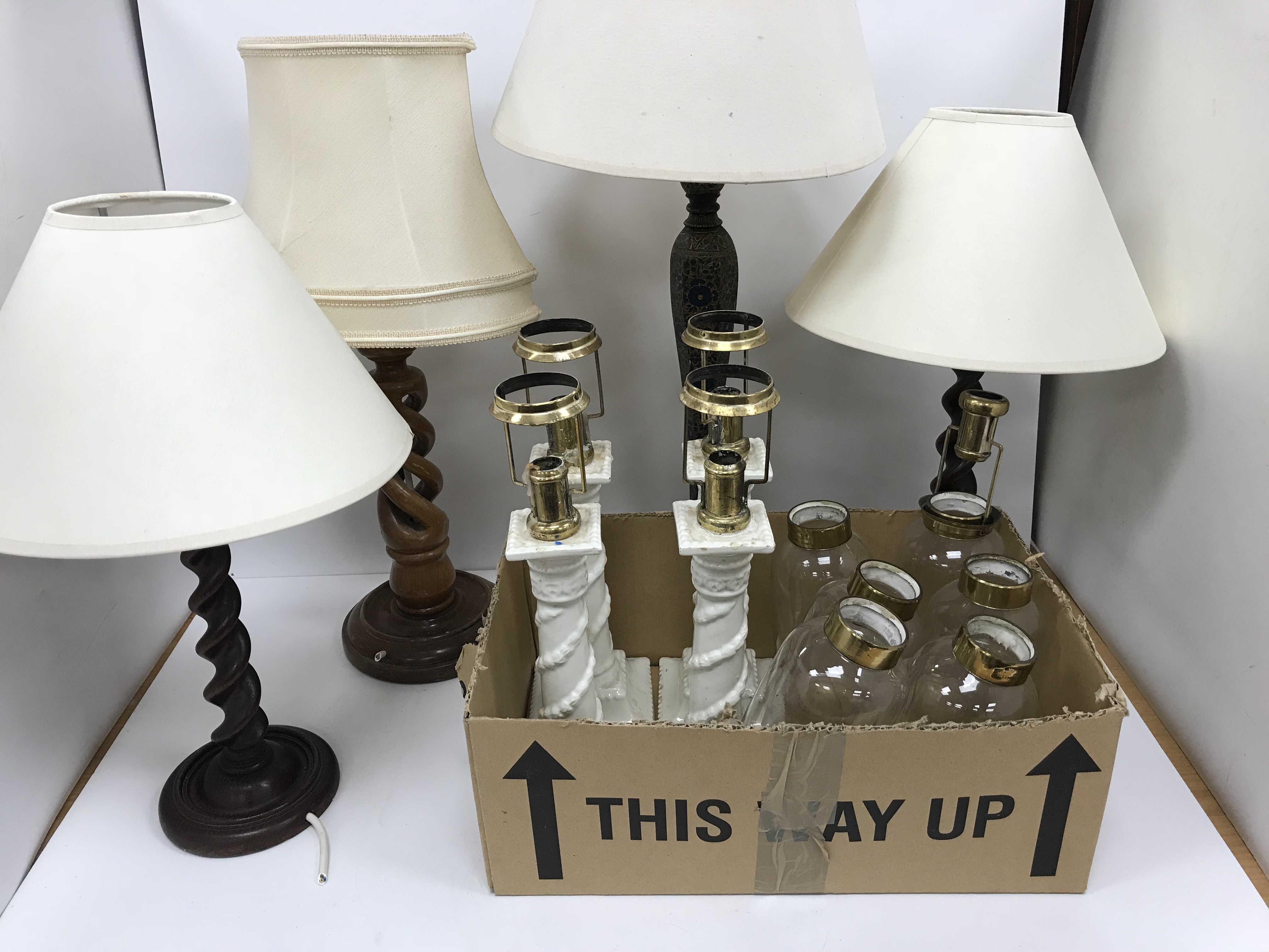 A box containing two pairs of barley-twist type table lamps,