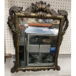 An 18th Century carved giltwood and gesso framed wall mirror with foliate and floral swag
