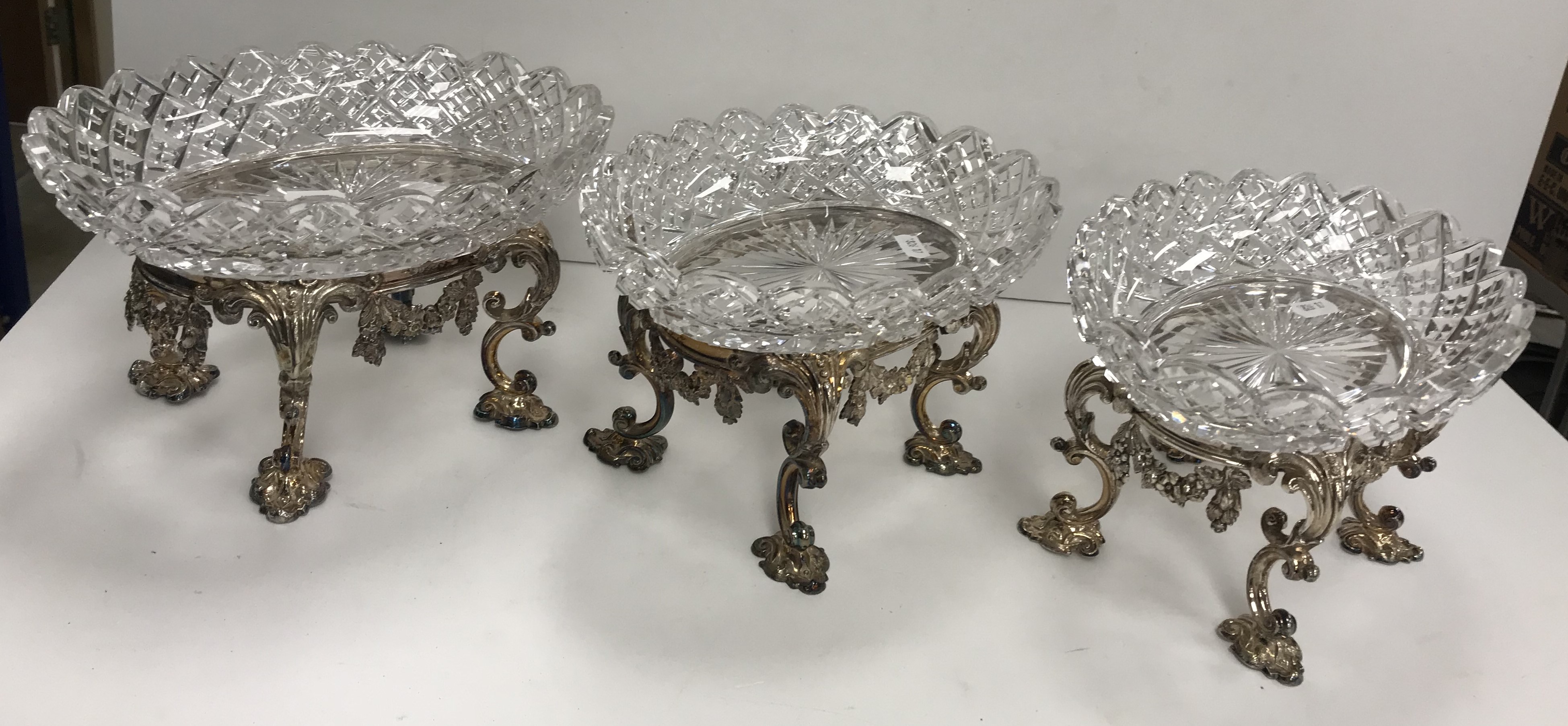 A set of three circa 1900 oval hobnail cut glass sweet meat dishes on electro plated stands in the