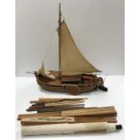 A collection of items to include a model Thames barge, a small African canoe model,