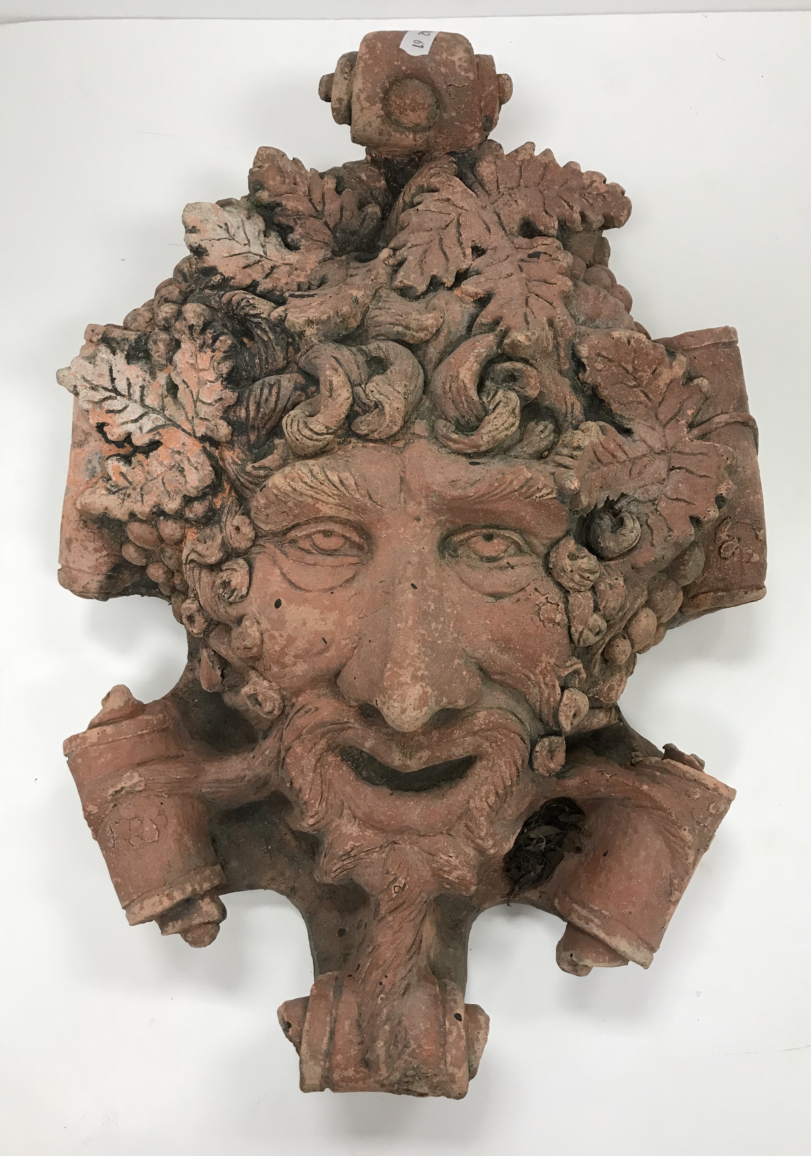 A terracotta wall plaque as the "Green man" amongst scrollwork, 30 cm x 43 cm, - Image 2 of 3