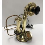 A vintage GEC brass candlestick telephone 30 cm high